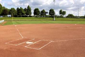 A view of a softball diamond at dusk. © Can Stock Photo / ca2hill