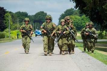 Members of 4th Battalion, The Royal Canadian Regiment conduct a fitness march at Cedar Springs, Ontario, July 16, 2022. File photo: courtesy of Cpl Aaron Beier / DND 2022.