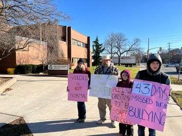 (From left to right) Briar Christensen, Ken Christensen, Rayna Dryden and Ashton Dryden protesting bullying and threats of violence outside the Lambton Kent District School Board Sarnia Education Centre. 13 December 2021.  (Photo by Blackburn Media Sarnia)