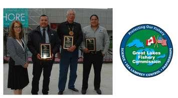 Great Lakes Fishery Commission Commissioner Tracey Mill (left) presents SON representatives (L-R) Head Councilor Conrad
Ritchie, Saugeen First Nation (representing Chief Lester Anoquot of the Saugeen First Nation); Chief Gregory Nadjiwon,
Chippewas of Nawash; Mr. Doran Ritchie, Saugeen Ojibway Nation with the 2018 C.D. Buzz Besadny Award for Fostering
Great Lakes Partnerships.   Not pictured: Ms. Kathleen Ryan, SON. The award was presented to the SON during the Great Lakes Fishery Commission’s 64th annual meeting in Detroit, Michigan. (Photo: T. Lawrence, GLFC.)