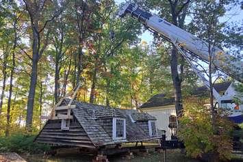 Canatara Cabin roof being moved by crane onto specially built frame (Photo courtesy of County of Lambton)