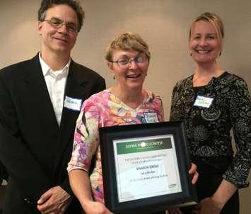 Patrick Dupuis and Marie-Hélène Gaudin of Coopérateur Magazine present Sharon Grose with framed certificate and check for her second place award at the Eastern Canadian Farm Writers Association annual general meeting in Ottawa. 