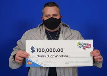 Denis Desbiens of Windsor shows off his $100,000 cheque at the OLG Prize Centre in Toronto. Photo provided by Ontario Lottery and Gaming.