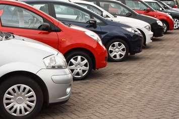 A used vehicle lot. Photo by Can Stock Photo/Stock Solutions.