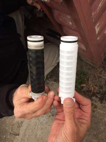 Filters before (right) and after (left) Dover well water runs through them. March 09, 2017.  (Photo by Paul Pedro)