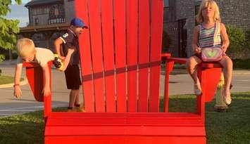 Hanging out in the big Red Chair. Photo from the Municipality of Central Huron.