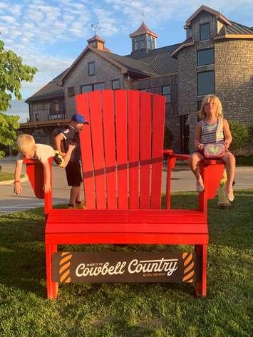 Hanging out in the big Red Chair. Photo from the Municipality of Central Huron.