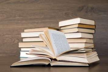 A stack of books sitting on a table. File photo courtesy of © Can Stock Photo / Pakhnyushchyy.