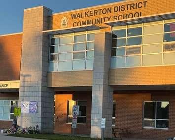 A flower memorial out front of Walkerton District Community School in honour of a teacher and four students killed in a crash northeast of London, May 25, 2025. (Photo by JC Coutts, Blackburn Media)