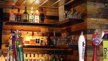 Alcohol on display behind the bar at Blazin' BBQ in Chatham (File photo by Jake Kislinsky)