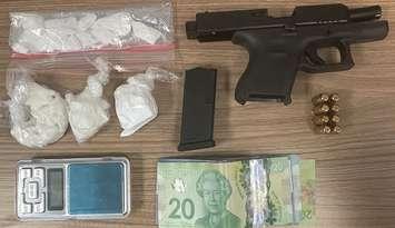 A handgun, illegal drugs, and cash seized after a vehicle was stopped at a RIDE checkpoint in Grey Highlands early Monday morning. 