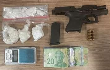 A handgun, illegal drugs, and cash seized after a vehicle was stopped at a RIDE checkpoint in Grey Highlands early Monday morning. 