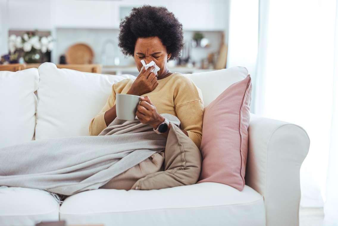 A woman blowing her nose while sick (Photo by: dragana991/ 	iStock / Getty Images Plus)