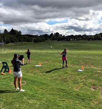 Kincardine's Brianna Cooper (lefto and holding tablet) helps young golfers as part of the Geared to Golf program. Submitted photo.