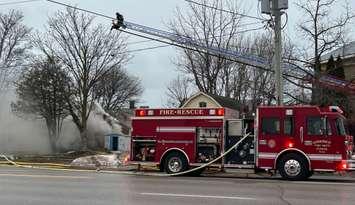 A firefighter sprays water on a house fire in Goderich on December 18, 2024. Photo by Julia DeJong.