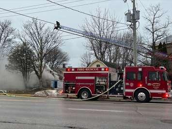 A firefighter sprays water on a house fire in Goderich on December 18, 2024. Photo by Julia DeJong.