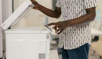A person using a printer. Photo provided by the Bruce County Public Library. 