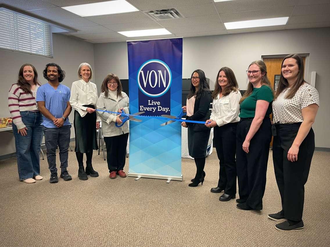 Deputy Mayor Diane Huber and Davina Wong cut ribbon at grand opening.    Left to right: Lindsay Haggle (Medical Secretary), Aman Sohrab (Nurse Practitioner), Jill Roote (Manager, Strategic Initiatives, Town of Saugeen Shores), Deputy Mayor Diane Huber, Davina Wong (Associate Vice President, Home and Community Care, VON), Colleen  Fowler (Nurse Practitioner), Elizabeth Clare (Nurse Practitioner), Karlee Sweiger (Nurse Practitioner). Photo from Saugeen Shores 