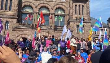 Demonstrators gather in front of the Legislative Assembly of Ontario on September 25.