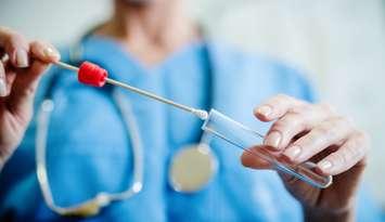 Doctor taking swab (Image by dusanpetkovic / iStock / Getty Images Plus via Getty Images)