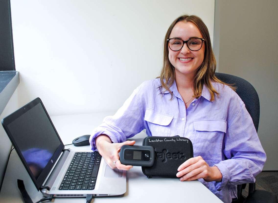 Ashlee Blackburn, Online Resource Communications Student, holds one of the Wi-Fi hotspots available to borrow from Lambton County Library (Submitted Photo)