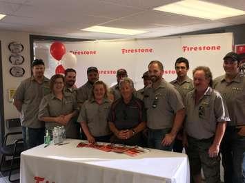 The staff at Kinfarm OK Tire pose with racing legend Mario Andretti, centre, at his meet-and-greet event in Bervie. August 22nd, 2019 (Photo by Ryan Drury)