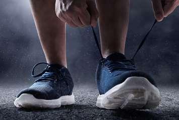 A person tying running shoes. © Can Stock Photo / fotokita