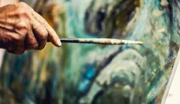 Artist painting on an easel (Image courtesy of MarijaRadovic /	iStock / Getty Images Plus via Getty Images) 