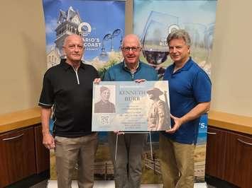 Tom St. Amand (L), Doug Woods, and Tom Slater (R) display a sign for the 'Sarnia War Remembrance Sign Project' - Oct. 22/24 (Blackburn Media Photo by Josh Boyce)