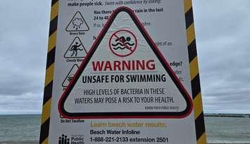 A sign advises the water at a Huron County beach is unsafe for swimming. Photo provided by @HuronBeachInfo on X