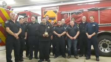 27-year-old Tyler McKay of Wingham was presented a bronzed trophy on behalf of the Wingham Firefighters Association for his countless help and volunteering over the years. (Photo by Craig Power, © Nov. 2016).