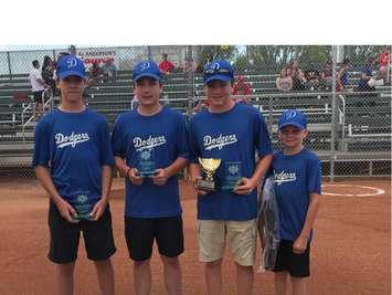 From left to right: Joseph Weiler, Kohan Ronnenburg, Dakota McComb, and Hunter McComb (Bat boy) are recgonized at the U14 Canadian Fast Pitch Championships in Saskatoon on July 30, 2019. (Picture courtesy of Daniel McComb)