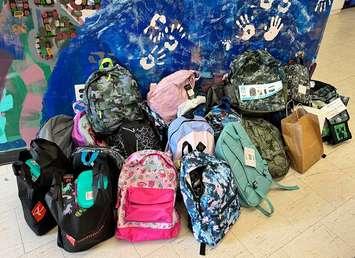 Donations of fully stocked backpacks made during the Stuff-A-Bus event at Grant's Your Independent Grocer in Hanover, August 25, 2024. Photo provided by United Way Bruce Grey