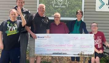 Robert K front left; Casey C back left; Mitch Wright, Director Community Living Wingham & District; Barry M in the middle, Anna Nicholson, Bruce Power Corporate Affairs & Market Development and Justin Z on the right. (Photo provided by Bruce Power)