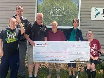 Robert K front left; Casey C back left; Mitch Wright, Director Community Living Wingham & District; Barry M in the middle, Anna Nicholson, Bruce Power Corporate Affairs & Market Development and Justin Z on the right. (Photo provided by Bruce Power)
