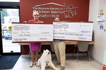 Jackie Strauss receives her winnings from the Humane Society of Kitchener Waterloo and Stratford Perth's 50/50 draw. Photo provided by Humane Society of Kitchener Waterloo and Stratford Perth