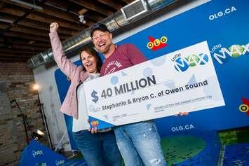 Stephanie and Bryan Cantwell pose with a prop cheque for $40-million, their half of the record Lotto Max jackpot from the September 17 draw. Photo courtesy of OLG. 