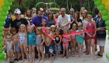 Saugeen Shores Mayor Mike Smith [middle, white shirt] had plenty of help as he cut the ribbon to open the Port Elgin and District Lions Club Splash Pad. (photo by Jordan MacKinnon) 