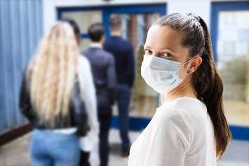 A woman wearing a face mask. © Can Stock Photo / AndreyPopov