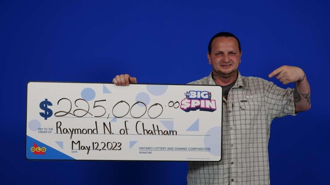 Raymond Nute, 43, of Chatham with his $225,000 winnings at the OLG Prize Centre in Toronto, Ont. (Source: OLG)