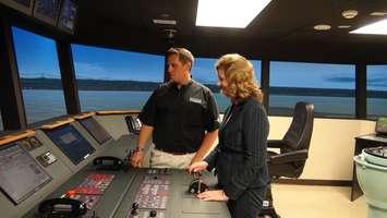 Georgian College President Marylynn West-Moynes with student Jason Davenport on the bridge simulator at Georgian College.  Photo by Kirk Scott.