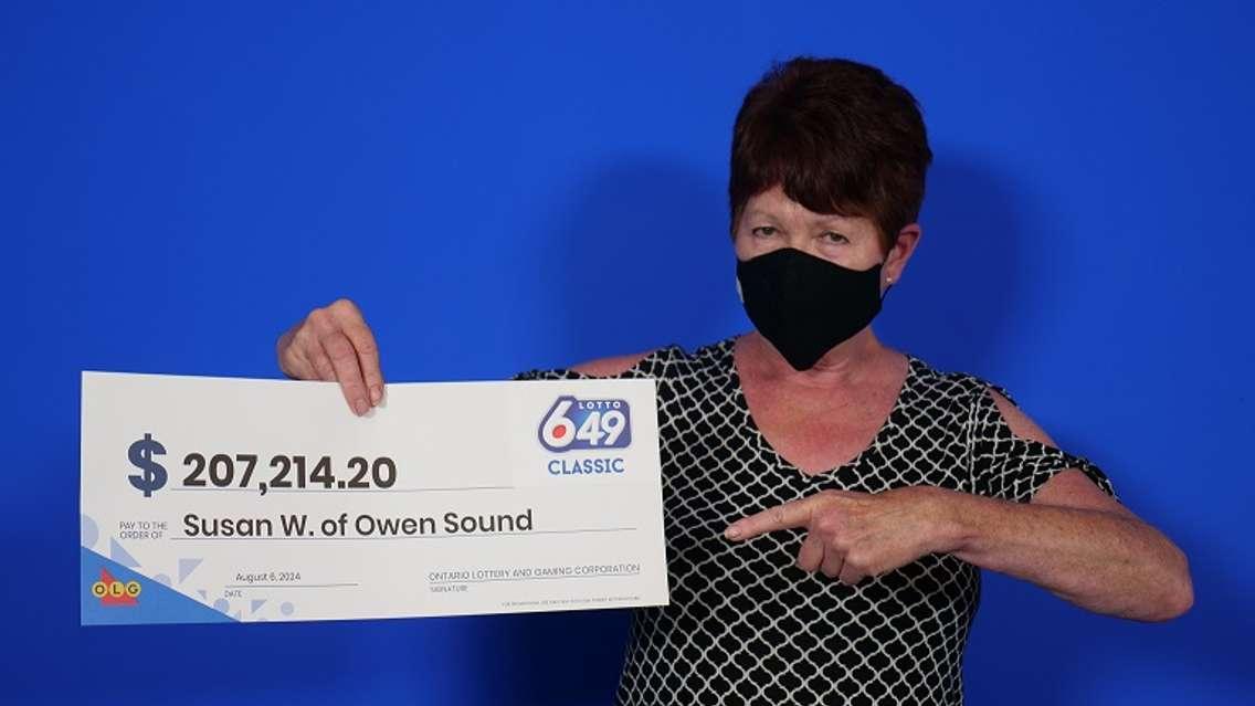 Susan Ward of Owen Sound with her winnings at the OLG Prize Centre in Toronto. Photo provided by OLG.