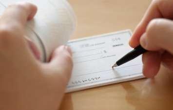Cheque.  Photo by payphoto / iStock / Getty Images Plus via Getty Images 
