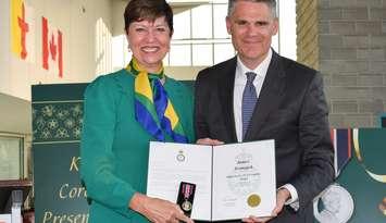 Pam Damoff, Member of Parliament for Oakville North-Burlington and Parliamentary Secretary to the Minister of Foreign Affairs, presents James Scongack with the King Charles III Coronation Medal on behalf of the Government of Canada.