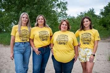 Suicide loss survivors Marnie Vandenbroek-Hookey, Leanne Fera and Chynna DaSilva join Suicide Loss Support Group Co-Facilitator Heather Taylor (third from right) to model t-shirts designed for Suicide Prevention Day on September 10. Submitted photo by Julie MacCrae Photography.