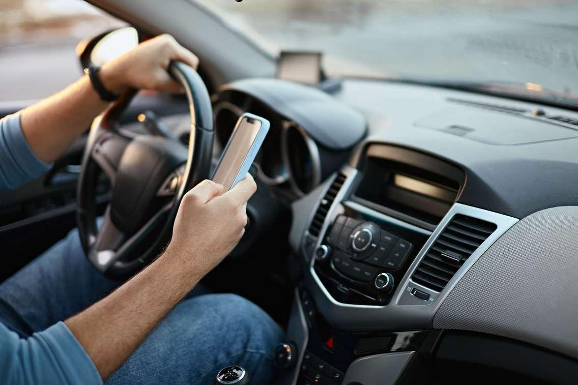 Someone texting and driving stock photo. (Photo by: perfectlab/ iStock/ Getty Images Plus)