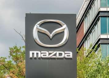 Mazda at the entrance of a car dealership (Image by Cristi Croitoru / iStock Editorial / Getty Images Plus)
