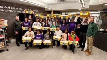 Students with the Windsor-Essex Catholic District School Board display materials donated by St. Clair College at the Catholic Education Centre in Windsor, December 19, 2024. Photo courtesy St. Clair College.