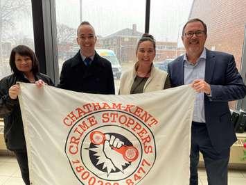 Left to Right: President of the Board Angie Shreve, Vice-President Aaron Hurst, Crime Stoppers Coordinator Erica McIntosh, and Mayor Darrin Canniff prepare to raise the Crime Stoppers flag.