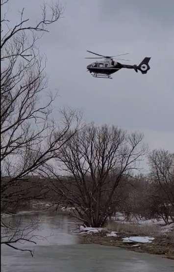 An OPP helicopter searching the river near Mitchell on March 8, 2022. (Image @PEFD_WPFD via Twitter)